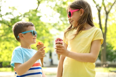 Photo of Cute little children with delicious ice creams outdoors