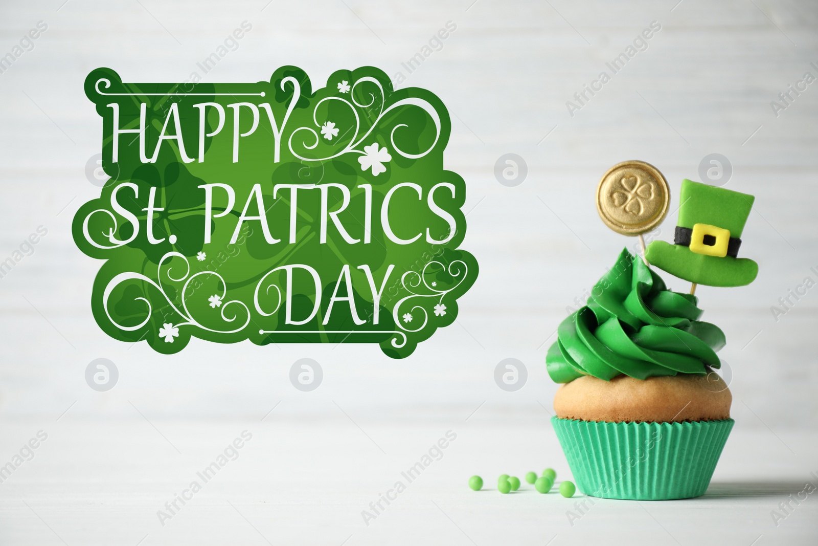 Image of Decorated cupcake on white wooden table. St. Patrick's Day celebration