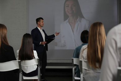 Photo of Video conference with female business trainer in office