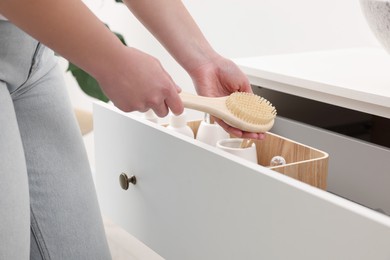 Photo of Bath accessories. Woman organizing personal care products indoors, closeup