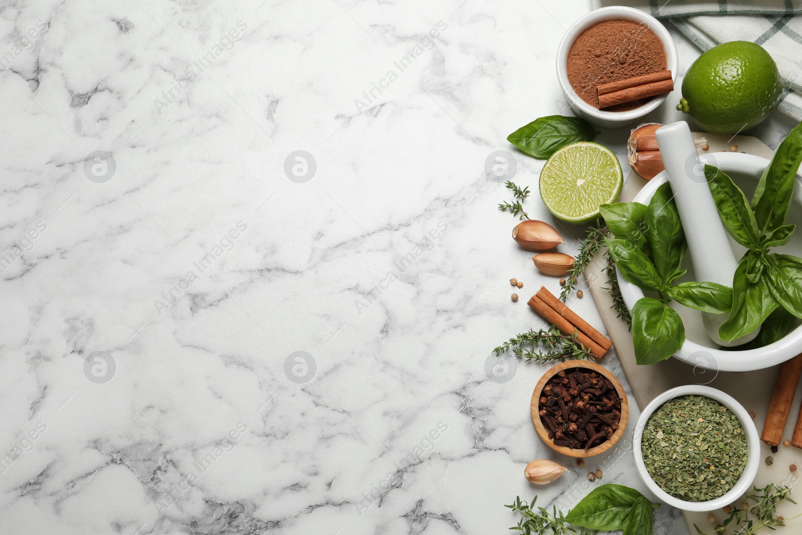 Photo of Different natural spices and herbs on white marble table, flat lay. Space for text