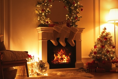 Photo of Fireplace with Christmas stockings in beautifully decorated living room