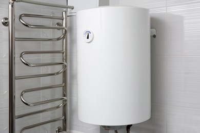 Photo of White boiler with temperature control indicator indoors