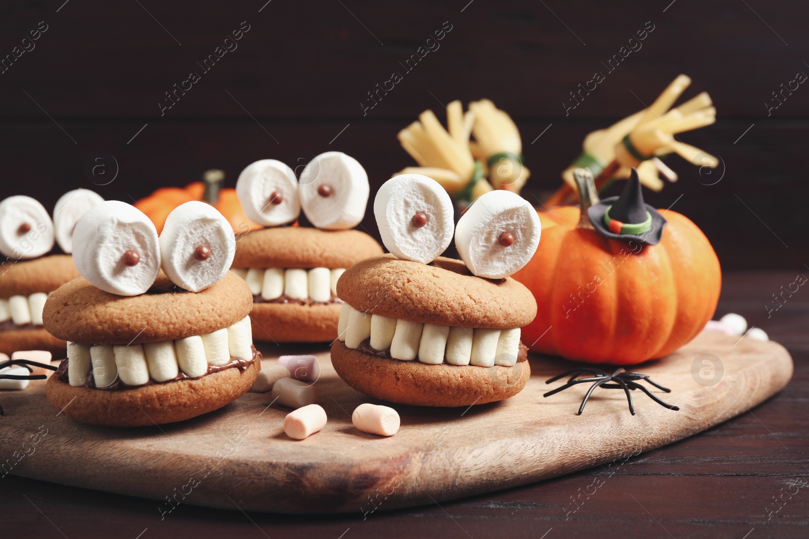 Photo of Delicious Halloween themed desserts on wooden table