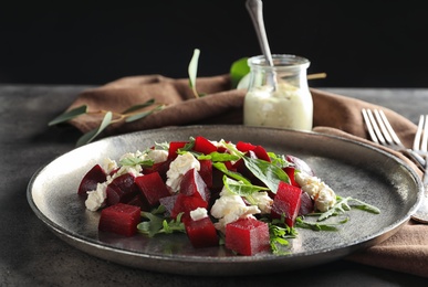 Plate with delicious beet salad served on table