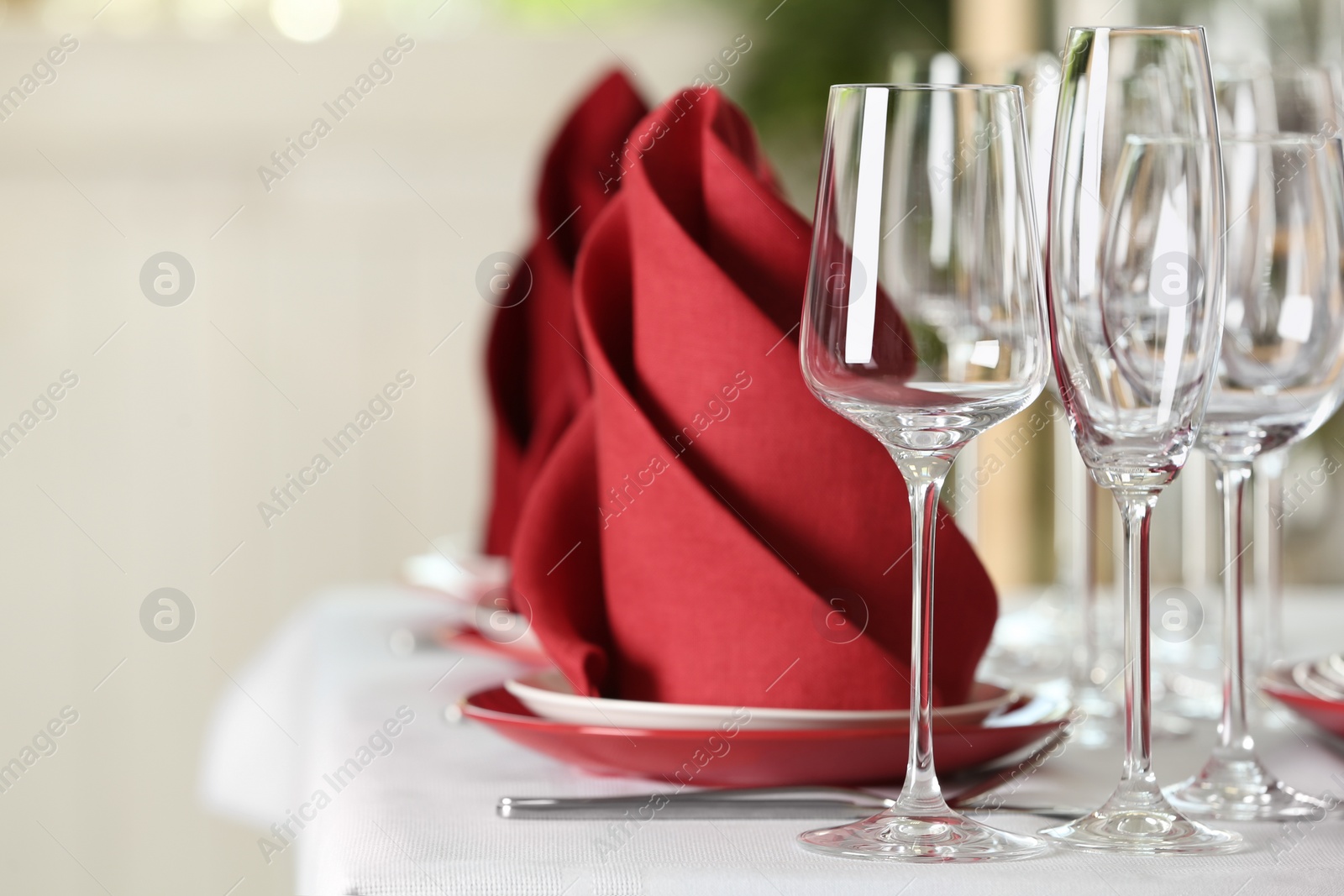 Photo of Table setting with empty glasses, plates and cutlery on table