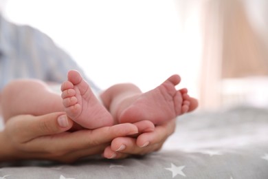 Mother and her little baby on bed, closeup