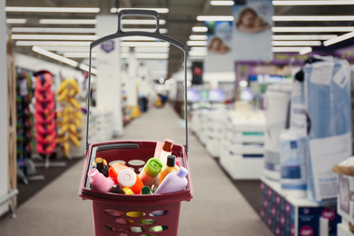 Image of Shopping basket full of cleaning supplies in mall