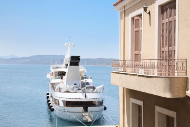 Beautiful boat in sea near building on sunny day