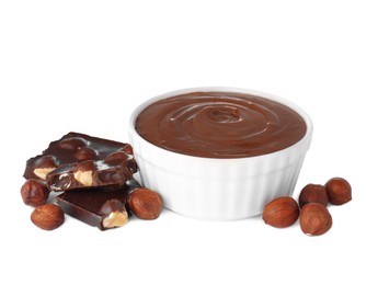 Photo of Chocolate pieces, bowl of sweet paste and hazelnuts on white background