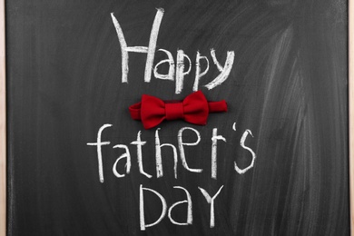 Photo of Phrase "Happy father's day" and bow tie on chalkboard