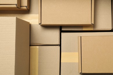 Photo of Many cardboard boxes as background, top view. Packaging goods