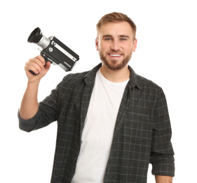 Young man with vintage video camera on white background