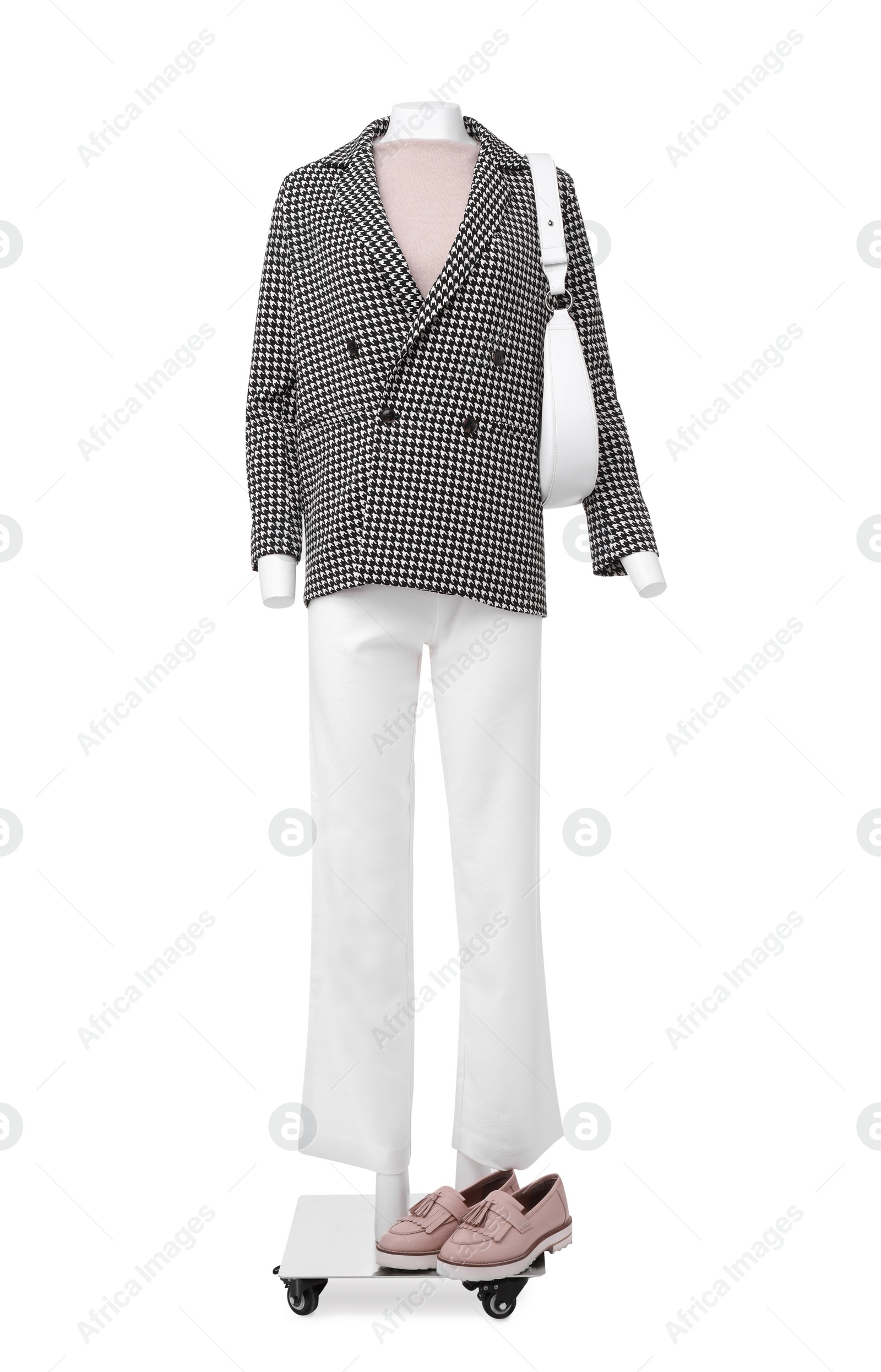 Photo of Female mannequin with bag dressed in stylish jacket, sweater and pants isolated on white