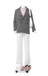 Female mannequin with bag dressed in stylish jacket, sweater and pants isolated on white