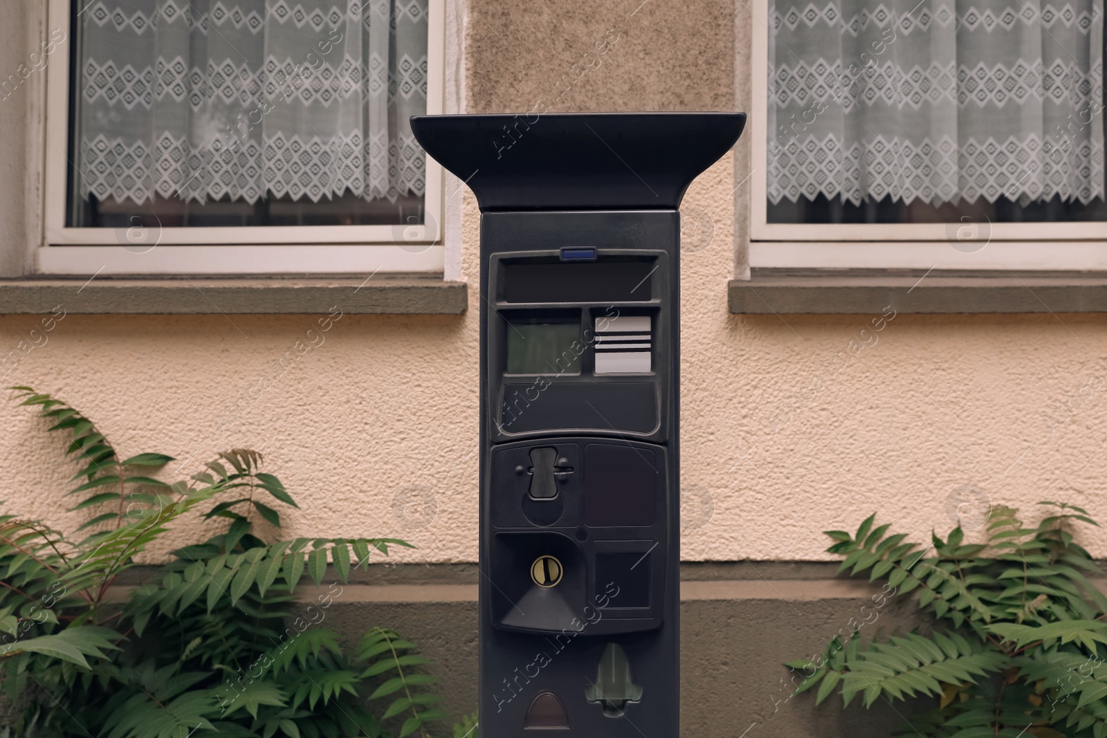 Photo of Parking meter near building on city street