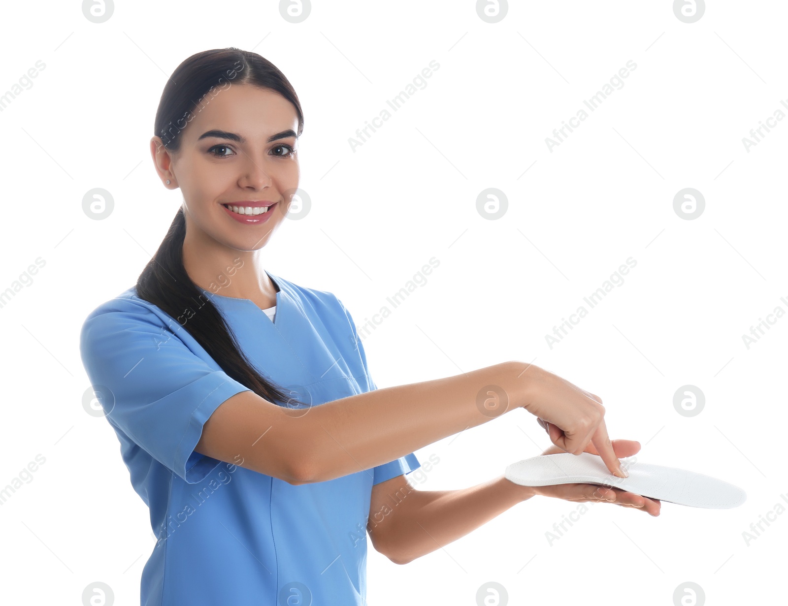 Photo of Female orthopedist showing insole on white background