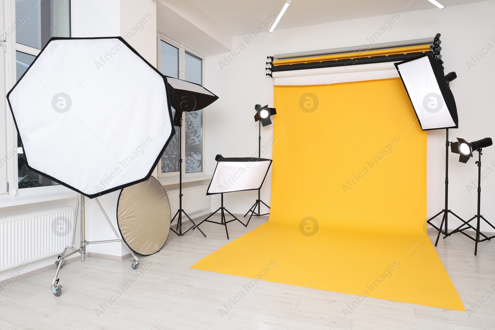 Photo of Interior of modern photo studio with professional lighting equipment