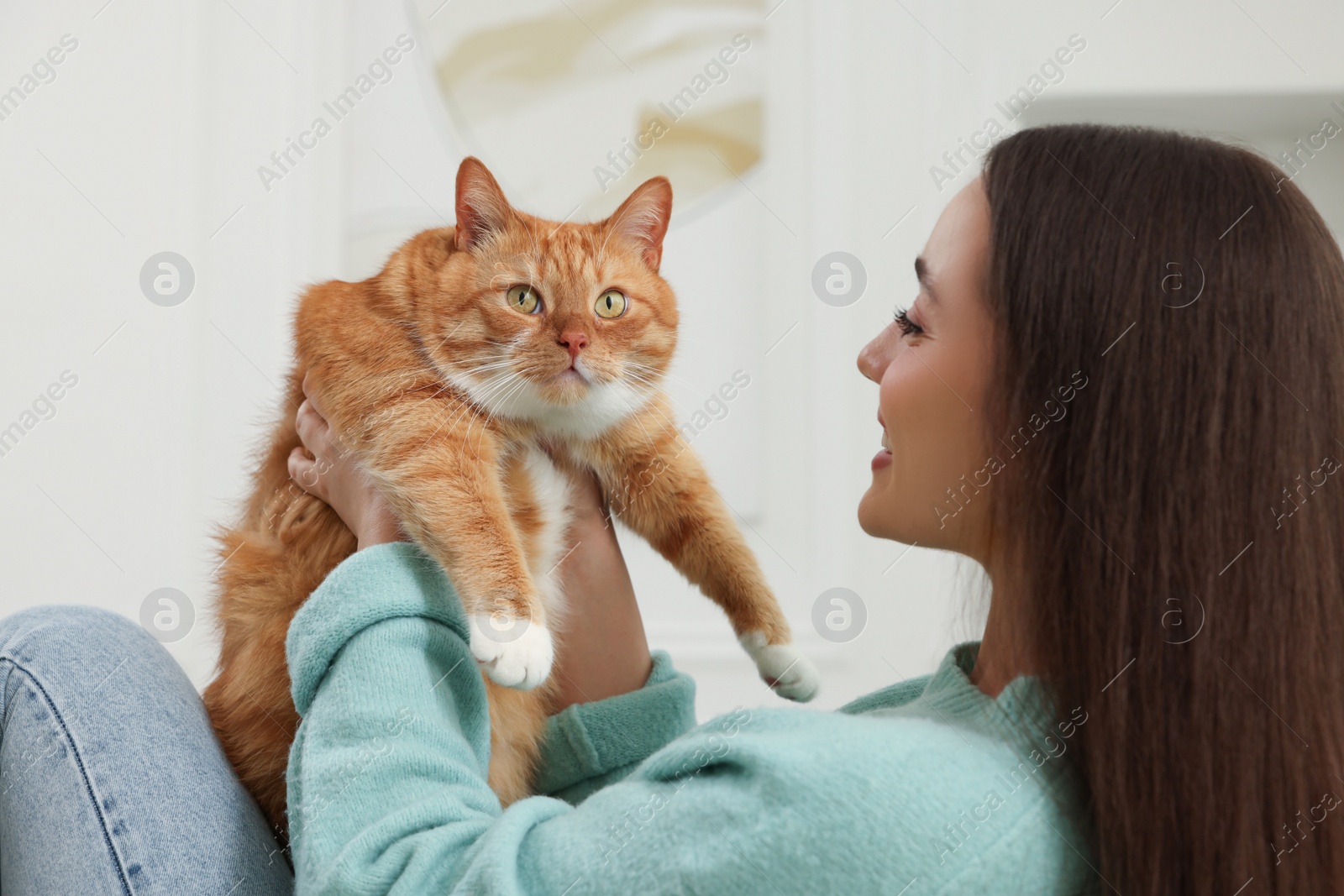 Photo of Beautiful woman with cute cat at home