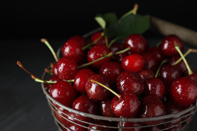 Photo of Sweet juicy cherries with water drops on dark background, closeup
