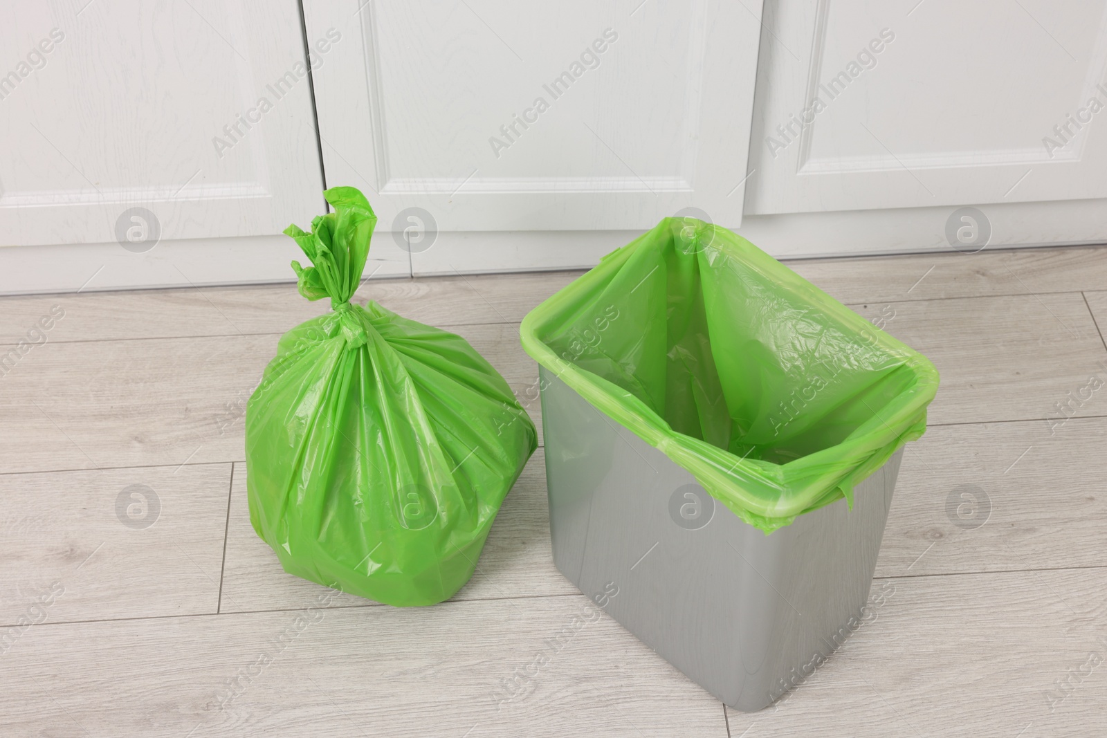 Photo of Plastic garbage bag and trash can indoors