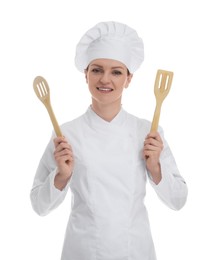 Photo of Happy woman chef in uniform holding wooden spatulas on white background