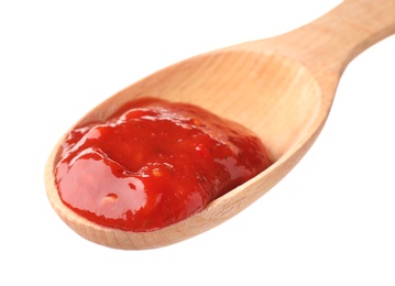 Photo of Wooden spoon with red sauce on white background