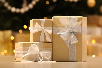 Beautifully wrapped gift boxes against blurred festive lights. Christmas celebration