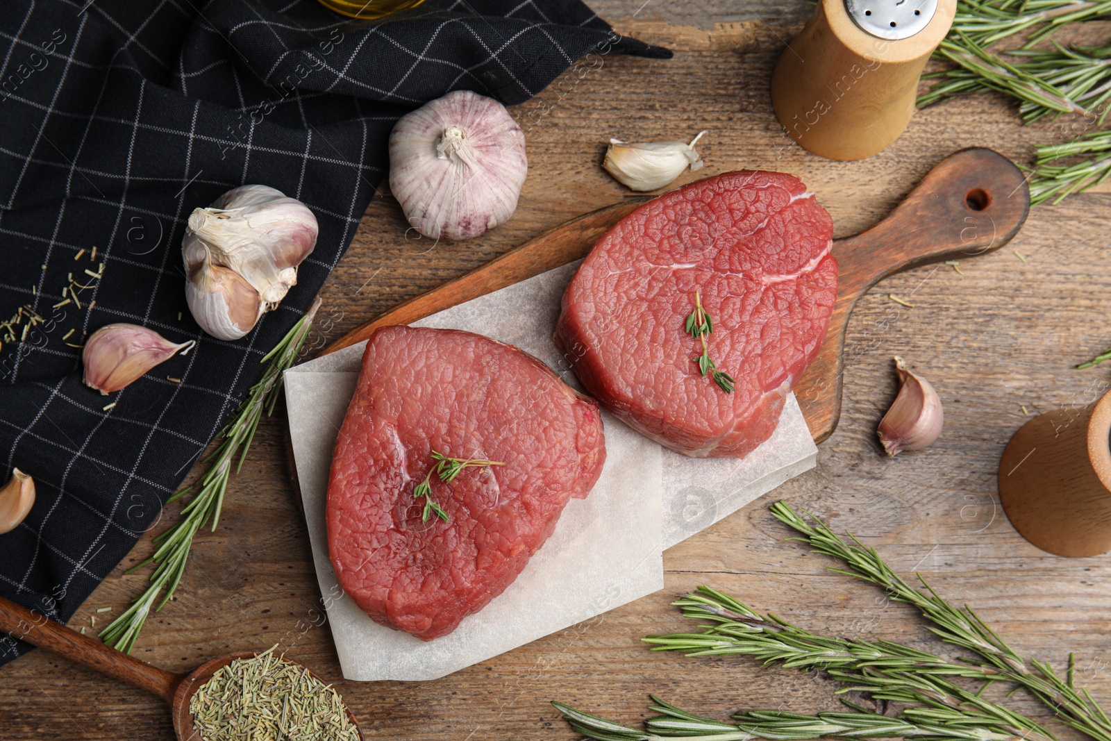 Photo of Flat lay composition with fresh beef cut on wooden table