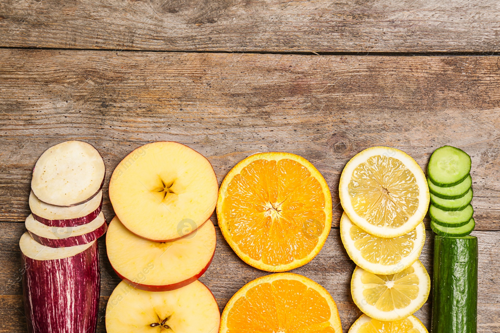 Photo of Rainbow composition with fresh vegetables and fruits on wooden background, flat lay