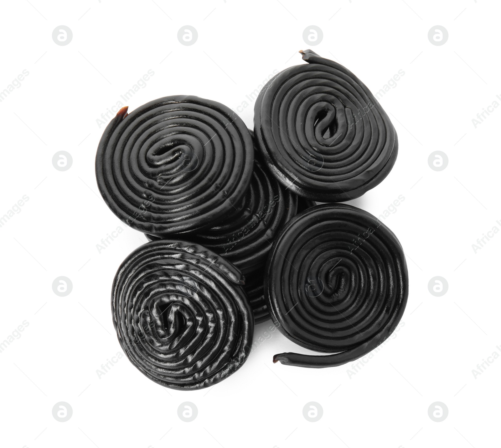 Photo of Tasty rolled liquorice candies on white background, top view