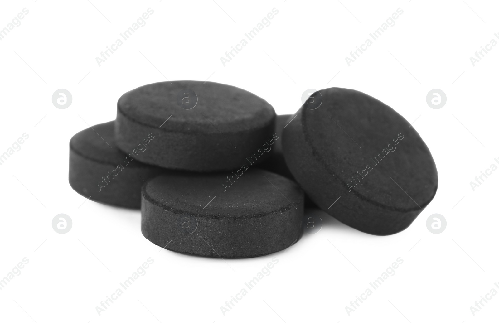 Photo of Activated charcoal pills on white background. Potent sorbent