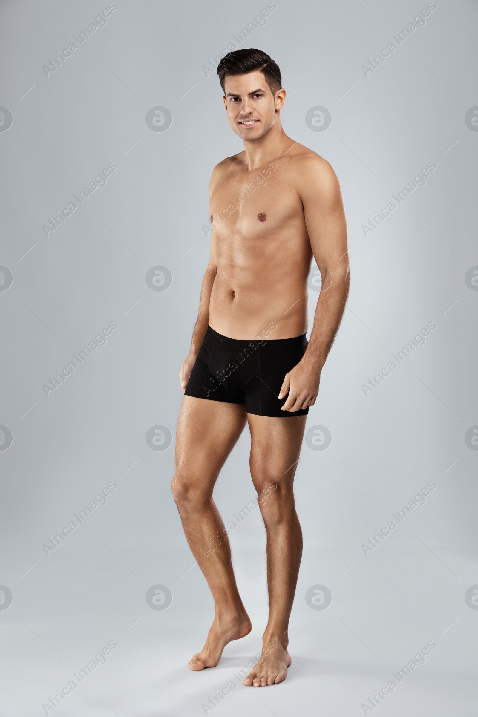 Photo of Handsome man in black underwear on light grey background