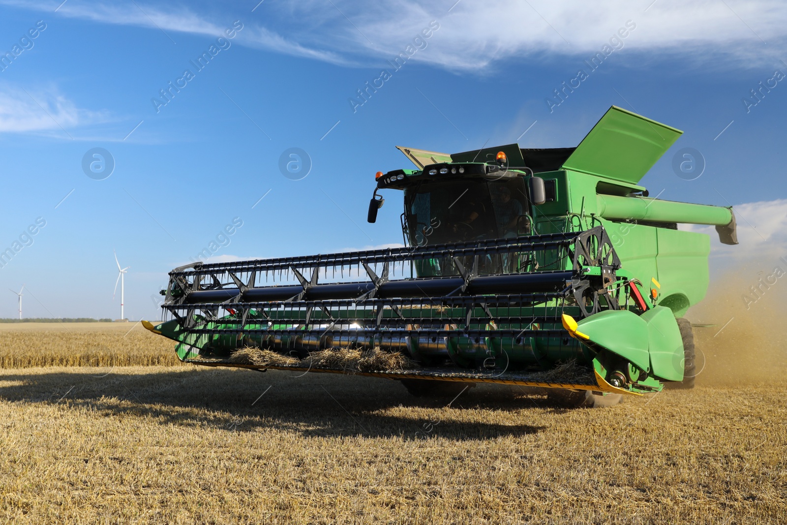 Photo of Modern combine harvester working in agricultural field