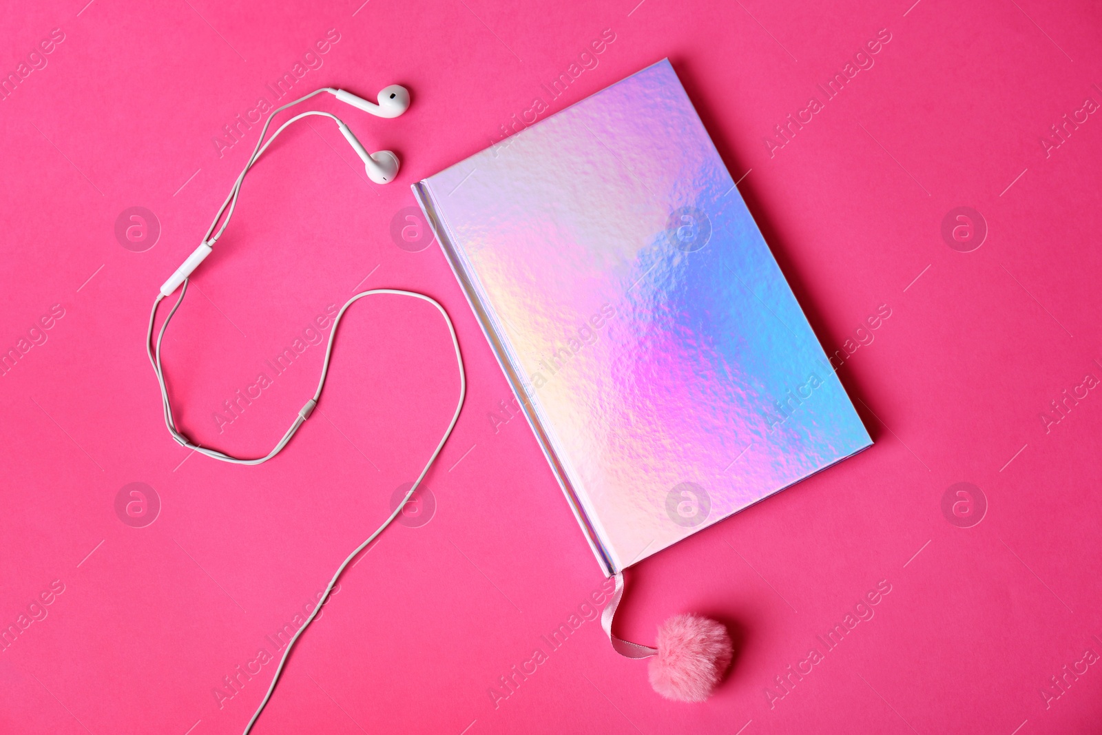 Photo of Stylish girl notebook and earphones on color background, flat lay