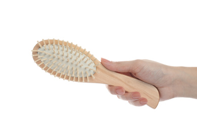 Photo of Woman holding wooden hair brush on white background, closeup