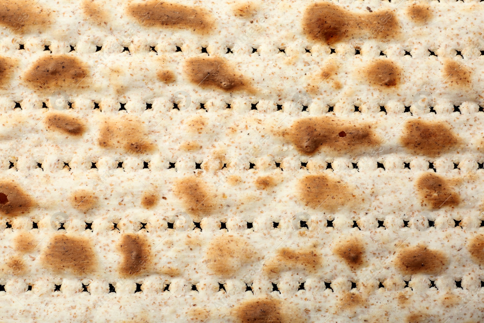 Photo of Traditional Matzo as background, top view. Pesach (Passover) celebration