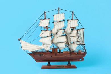 Photo of Beautiful ship model on light blue background