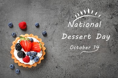 Image of National Dessert Day, October 14. Tartlet with different fresh berries on grey table, top view