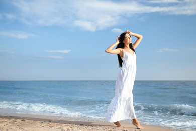 Photo of Young beautiful woman at beach on sunny day