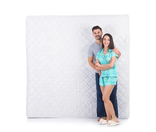 Photo of Young couple with comfortable mattress isolated on white