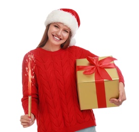 Photo of Happy young woman in Santa hat with Christmas gift and sparkler on white background