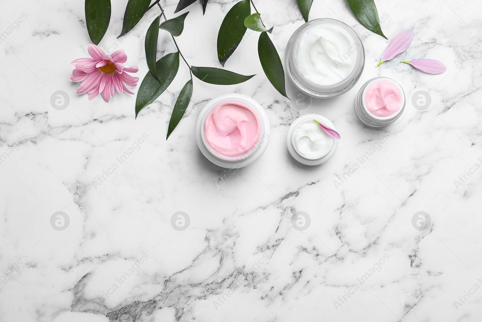 Photo of Composition with body cream in jars on light background