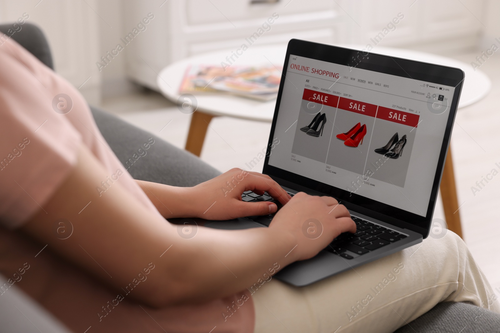 Photo of Woman shopping online during sale on laptop at home, closeup