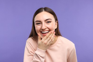 Photo of Portrait of beautiful woman laughing on violet background
