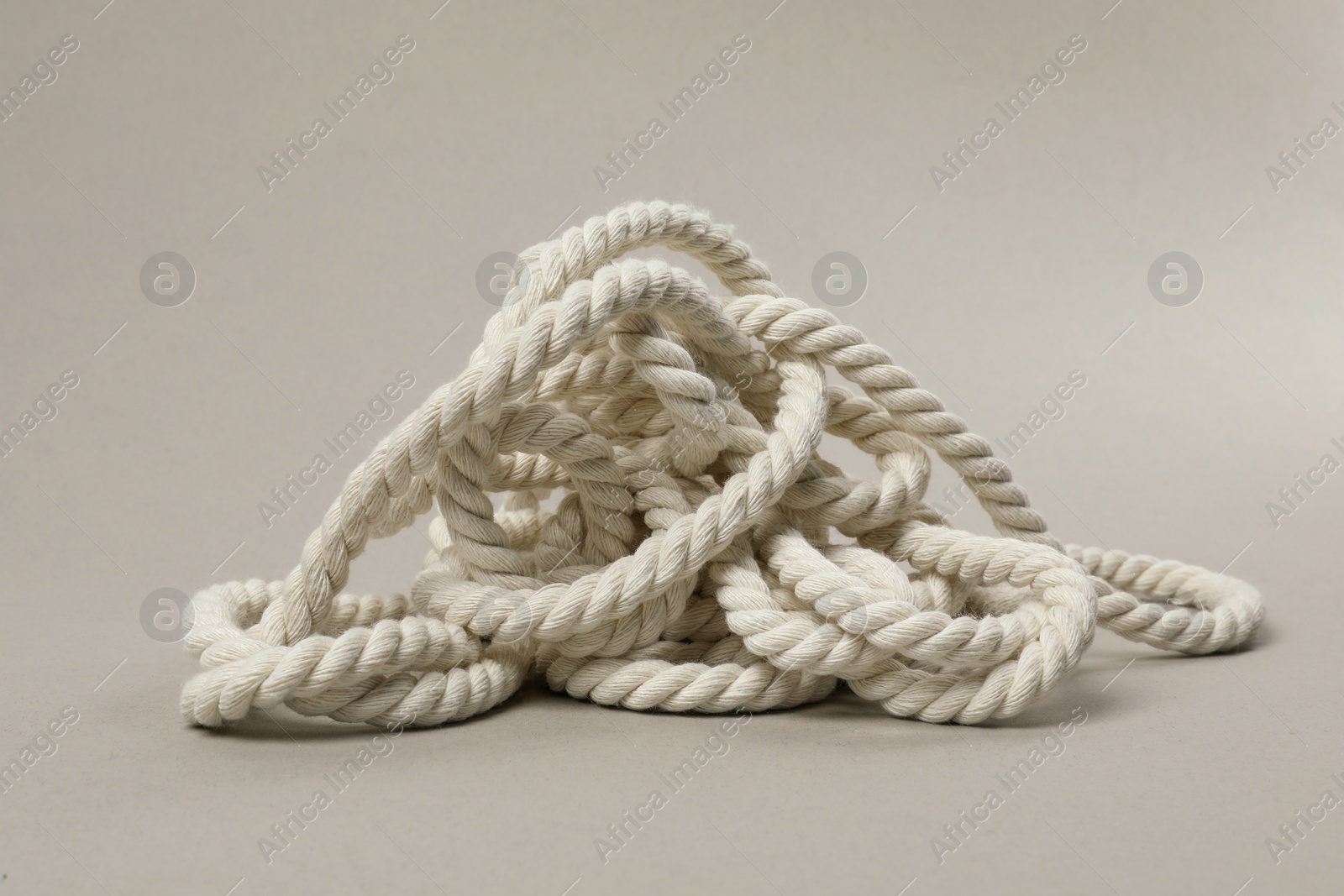 Photo of Bundle of hemp rope on light grey background