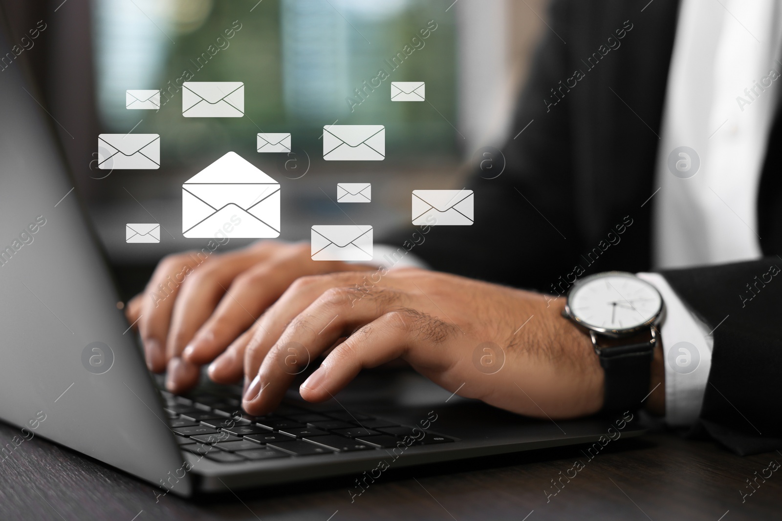 Image of Email. Man using laptop at table, closeup. Letter illustrations over device