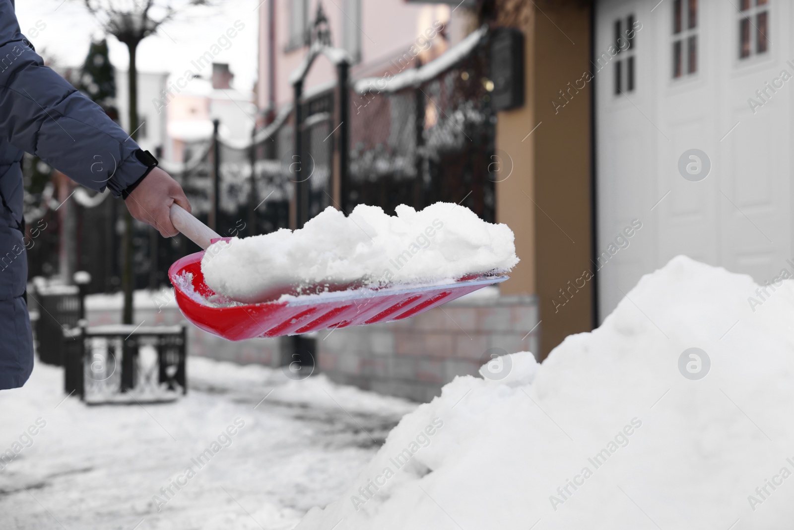 Photo of Man shoveling snow on city street, closeup