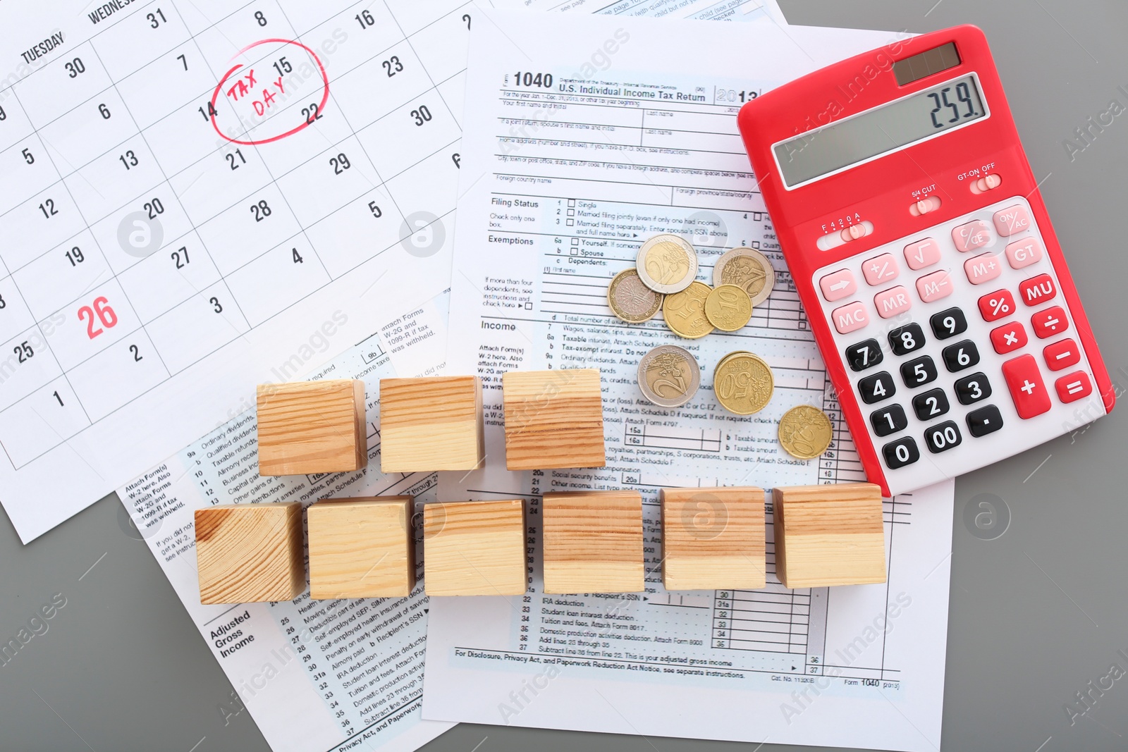 Photo of Flat lay composition with documents, calculator and wooden cubes on table. Tax day