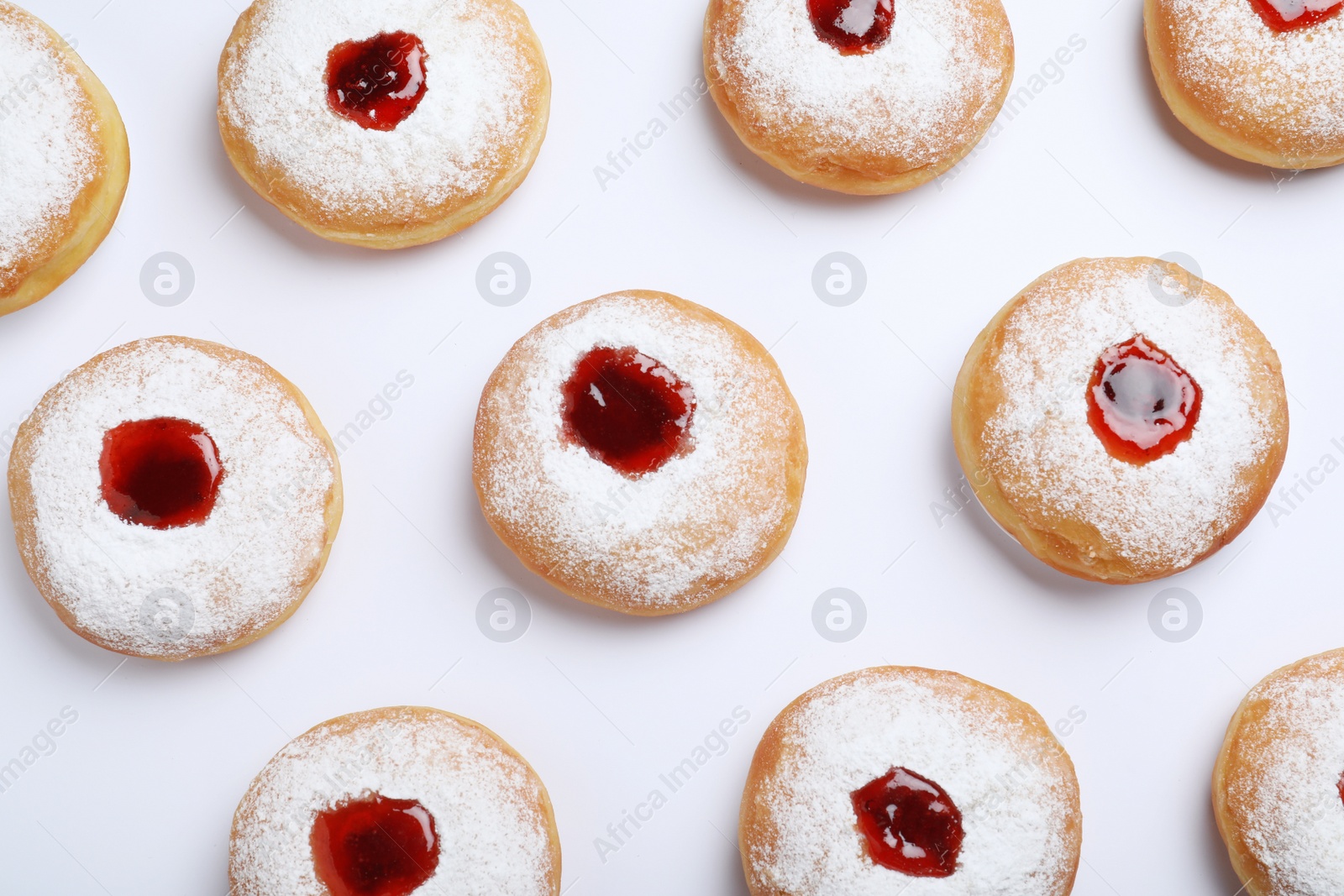 Photo of Hanukkah doughnuts with jelly and sugar powder on white background, top view